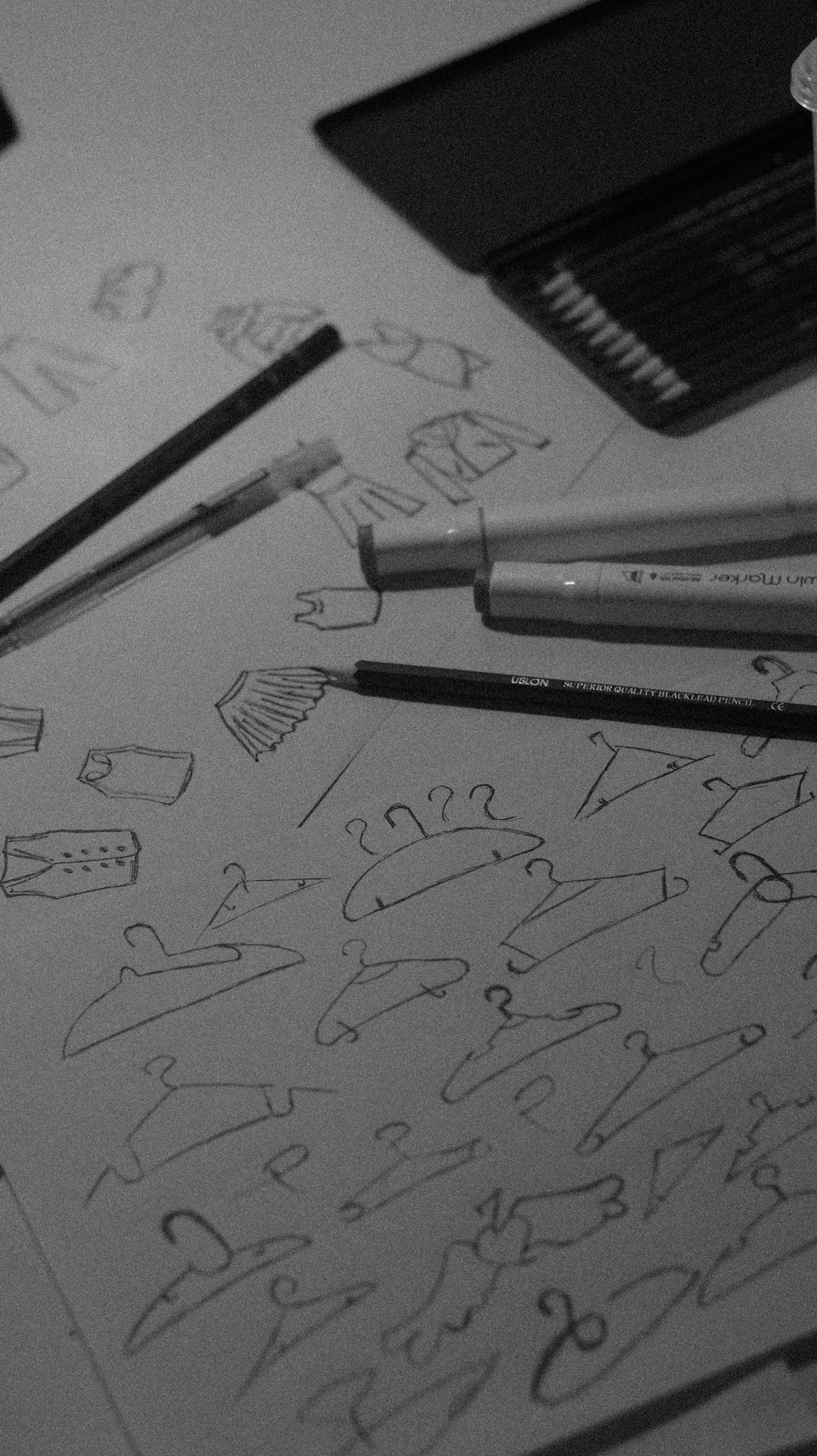 sketches-of-clothes-and-hangers-with-pencils-and-pens-uagdu8wxl58