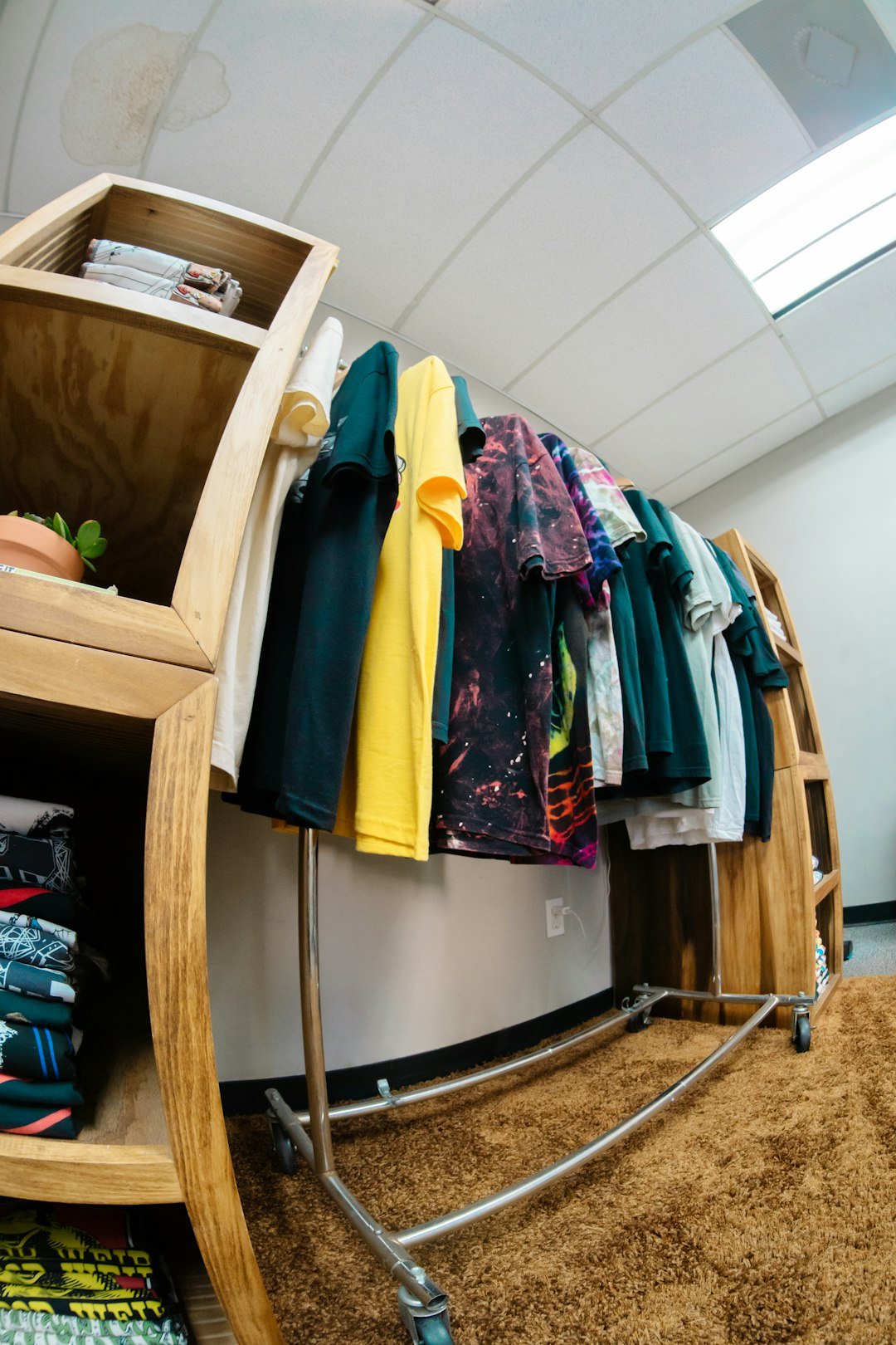 Home t-shirts-hanging-on-a-rack-in-a-store-wwcvj4dtzpg
